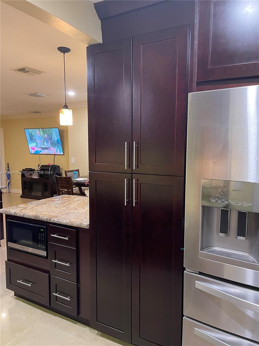 11810 Southwest 176th Street Miami, FL 33177 - Photo 6 of 15 a kitchen with a refrigerator and cabinets