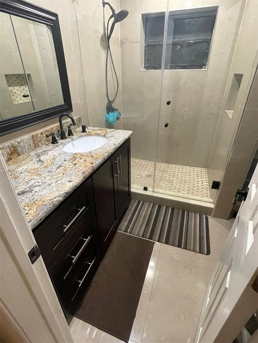 11810 Southwest 176th Street Miami, FL 33177 - Photo 9 of 15 a bathroom with a sink and a mirror