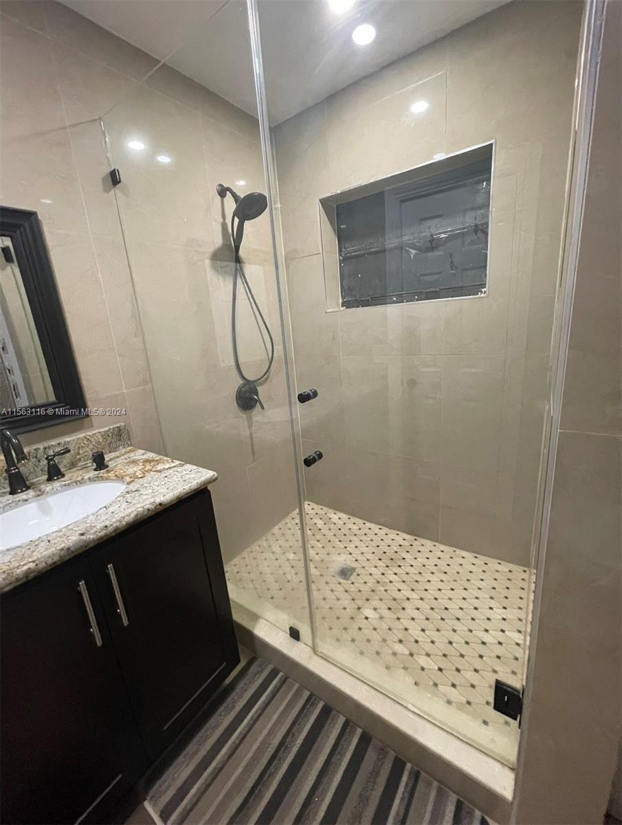 11810 Southwest 176th Street Miami, FL 33177 - Photo 10 of 15 a bathroom with a sink and a mirror