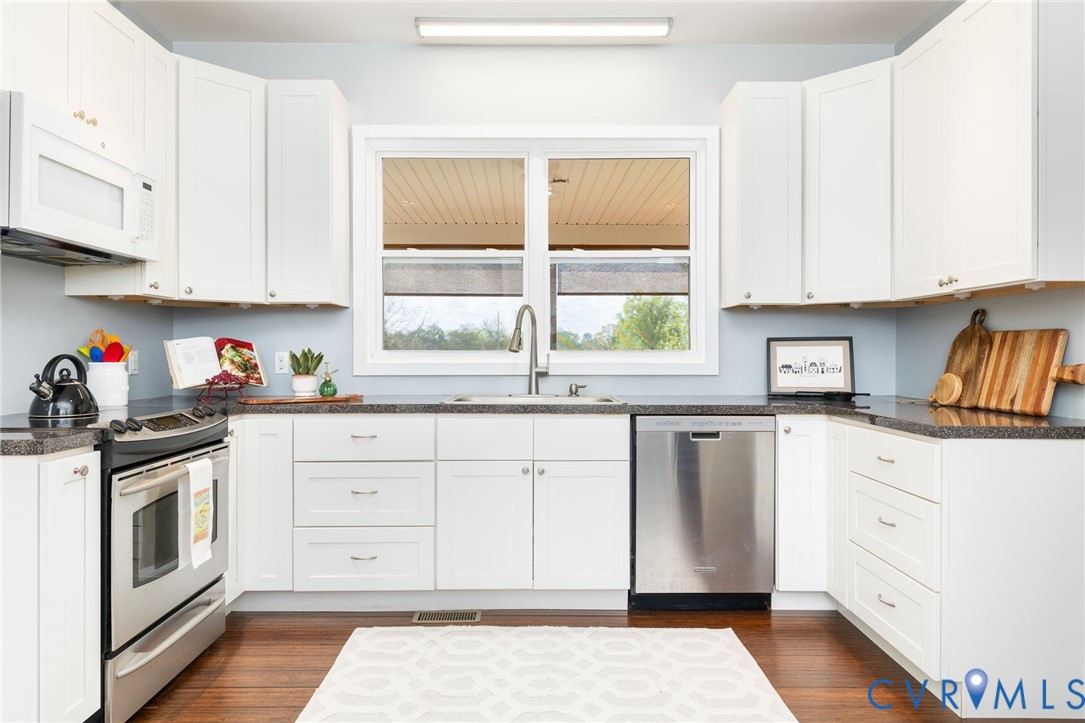 1895 Cemetery Road Chase City, VA 23924 - Photo 13 of 83 a kitchen with granite countertop white cabinets and white appliances