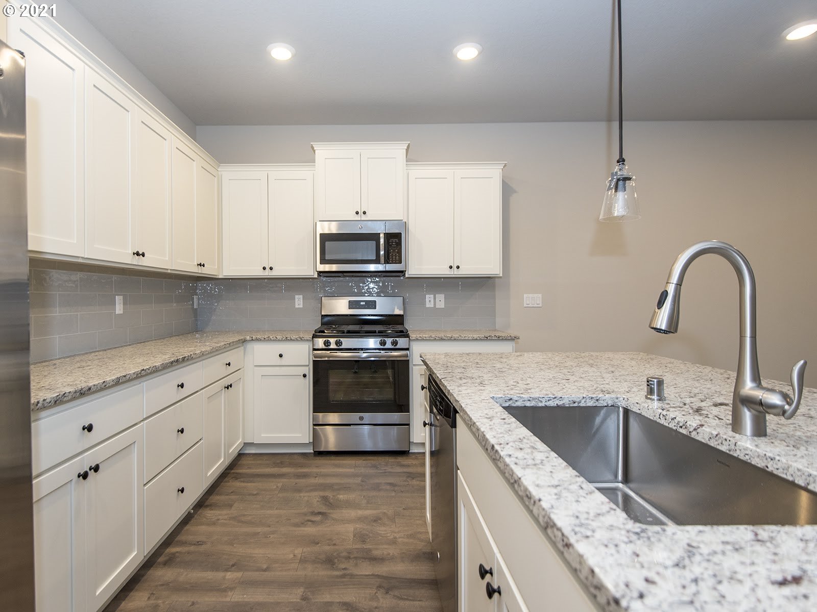 3712 South 42nd Place Ridgefield, WA 98642 - Photo 20 of 29 a kitchen with stainless steel appliances granite countertop a sink a stove and a granite counter tops