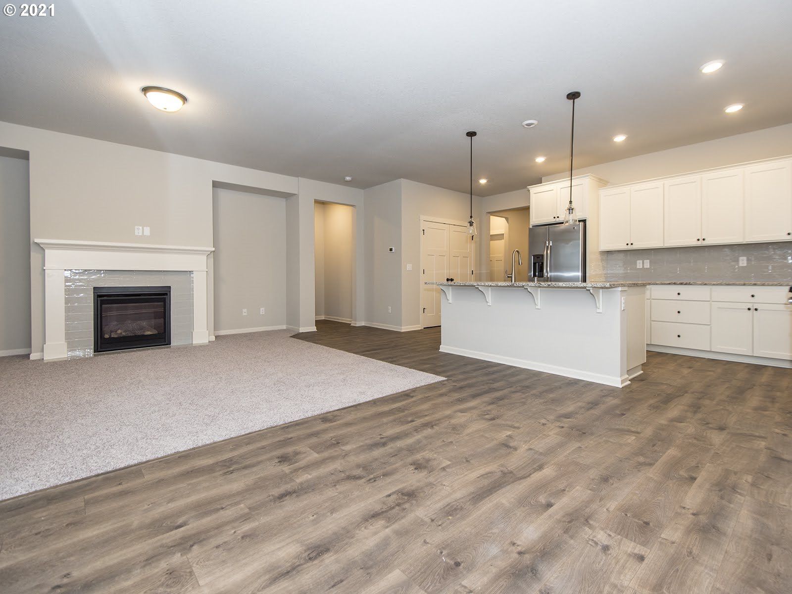 3712 South 42nd Place Ridgefield, WA 98642 - Photo 10 of 29 a view of a kitchen with a stove cabinets and a wooden floor