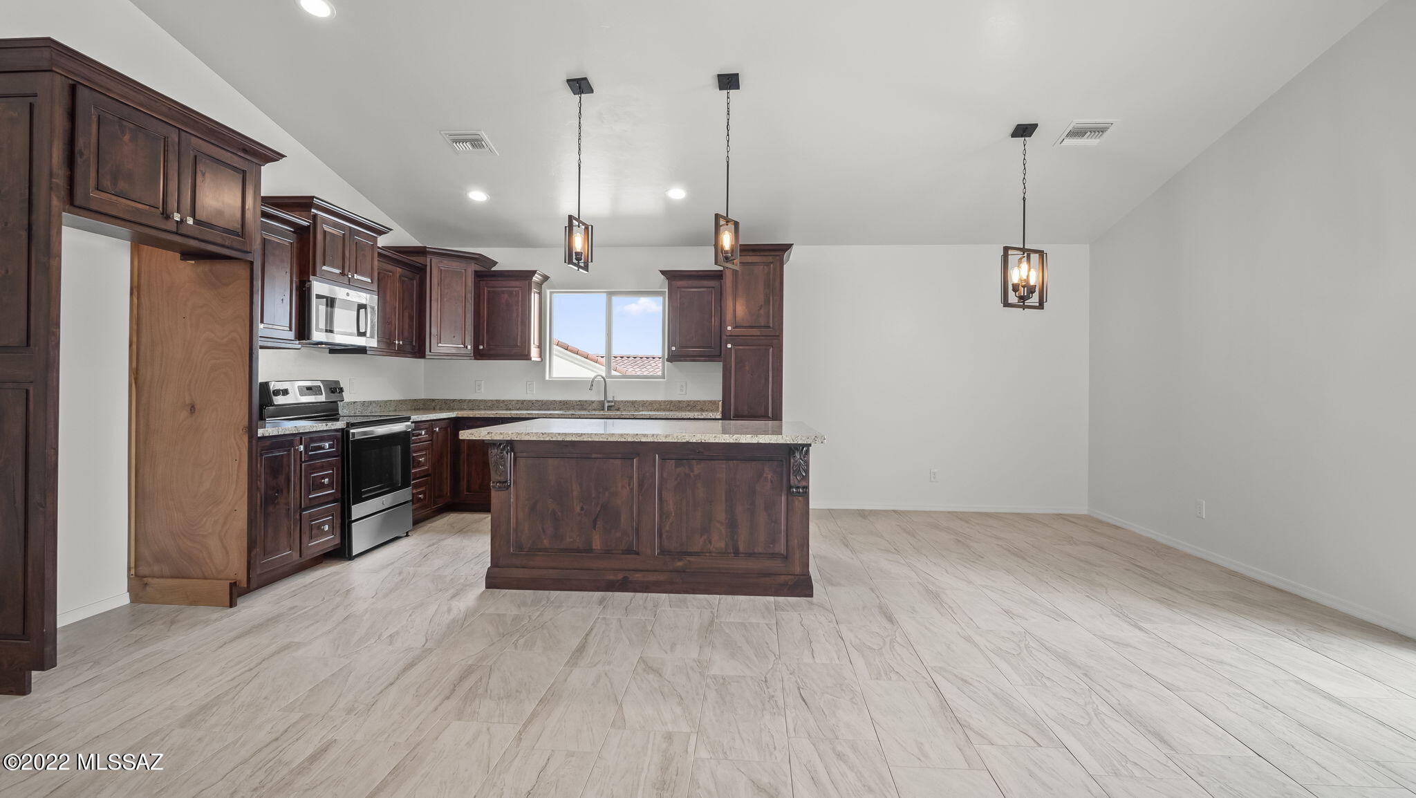 393 Quail Court Rio Rico, AZ 85648 - Photo 5 of 21 a kitchen with stainless steel appliances granite countertop a sink a stove and a wooden floors