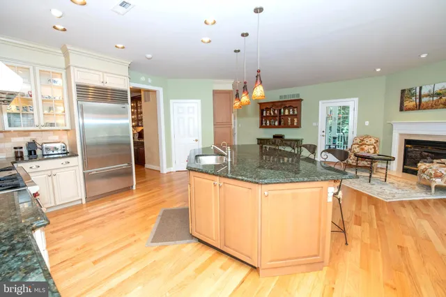 a living room with furniture potted plant and a large window