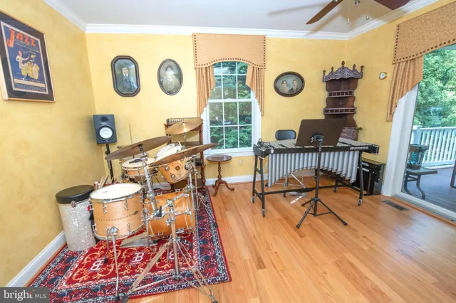 a living room with furniture a bookshelf and a flat screen tv