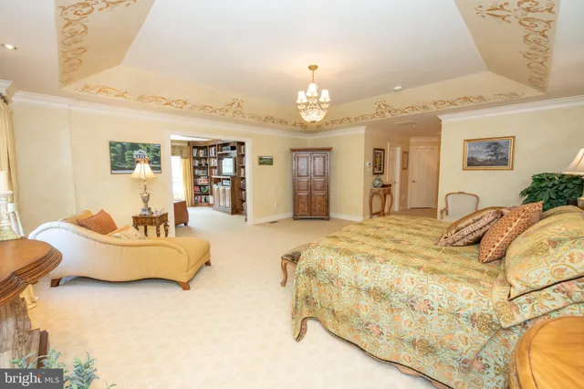 a bedroom with a bed and a chandelier
