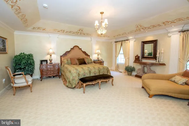a living room with furniture a window and a chandelier