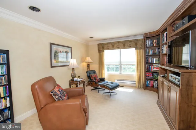 a bathroom with a toilet a sink a mirror and a window