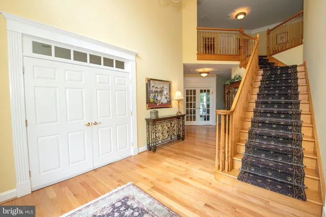a dining room with furniture a chandelier and wooden floor