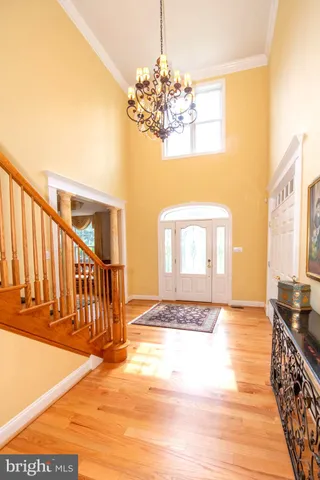 a dining room with furniture a chandelier and wooden floor