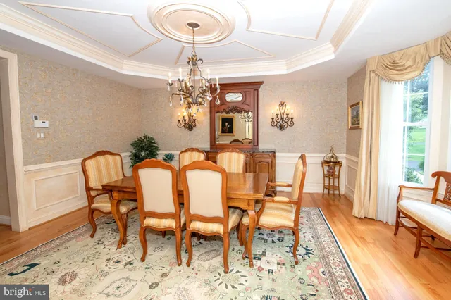 a living room with fireplace furniture and a table