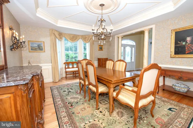 a large kitchen with stainless steel appliances kitchen island granite countertop a large window and a counter top space