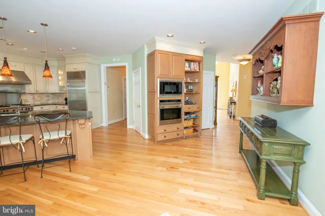 a kitchen with a stove top oven and a refrigerator