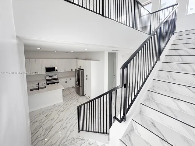 a spacious bathroom with a double vanity sink a mirror and a