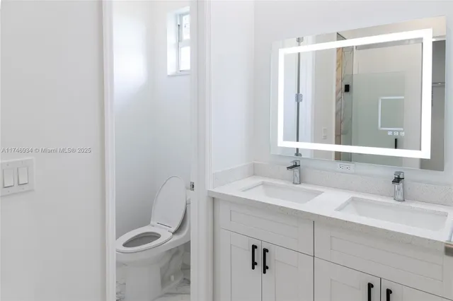 a view of a bathroom with a sink and a mirror