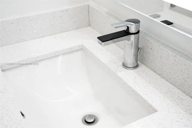 a bathroom with a sink toilet and a mirror