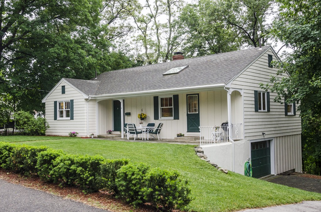a front view of house with a garden and patio