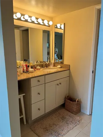 a bathroom with a double vanity sink and mirror