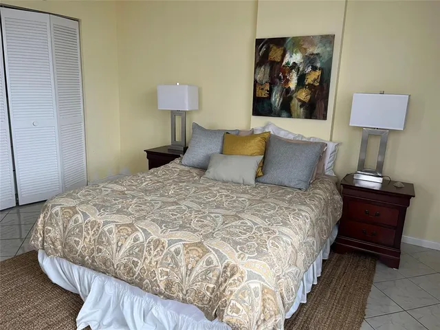 a bedroom with a bed and a lamp on table