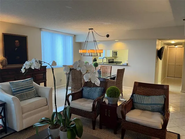 a living room with furniture a rug and a chandelier