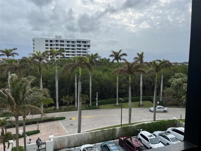 a view of a terrace with chairs and floor to ceiling window
