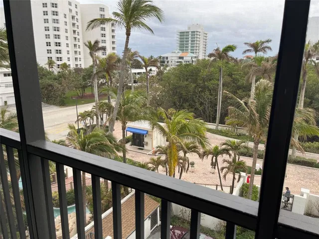 a view of a balcony with wooden floor and outdoor space
