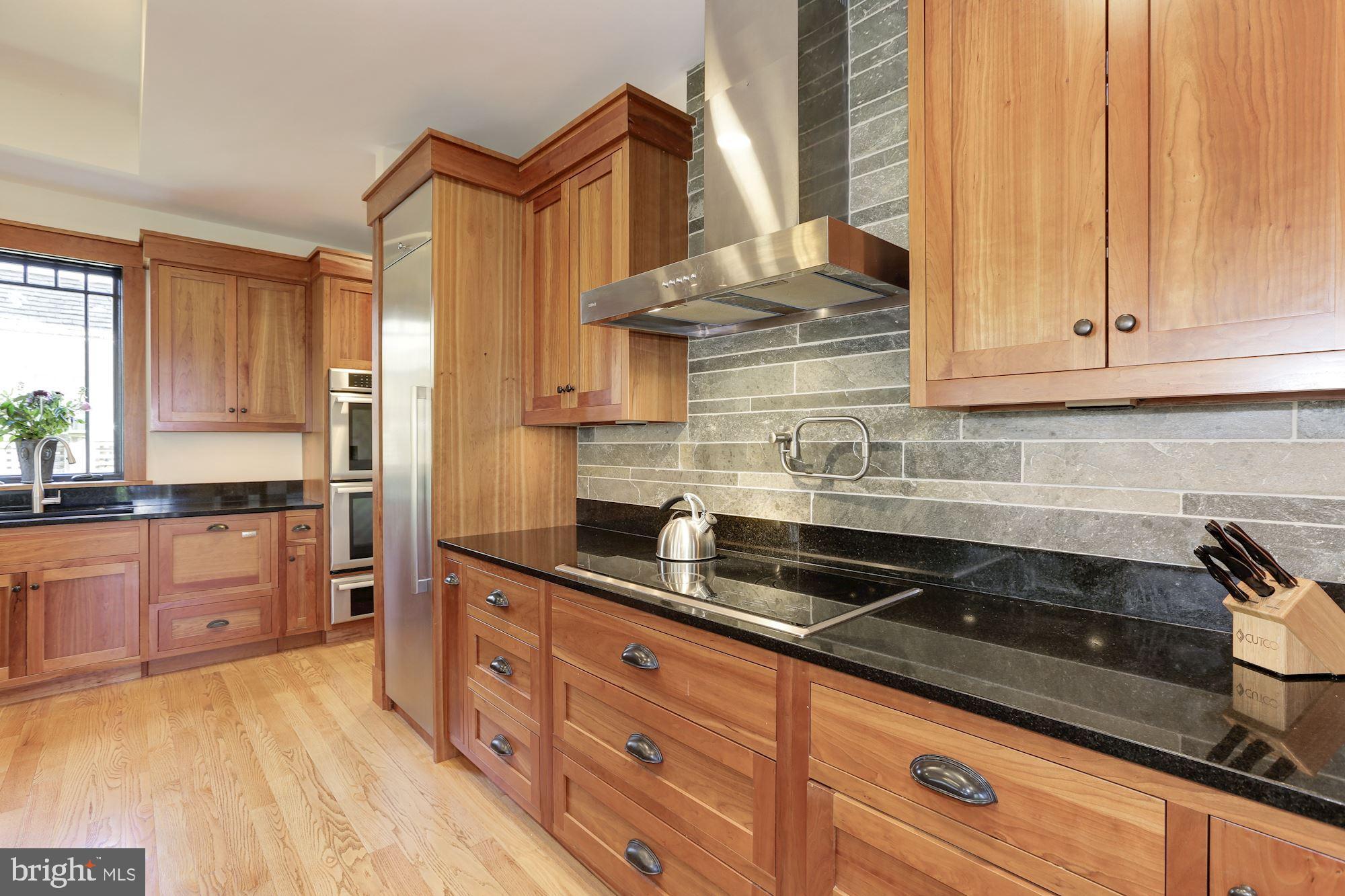 5631 Newington Road Bethesda, MD 20816 - Photo 13 of 96 Kitchen with counter to ceiling backsplash