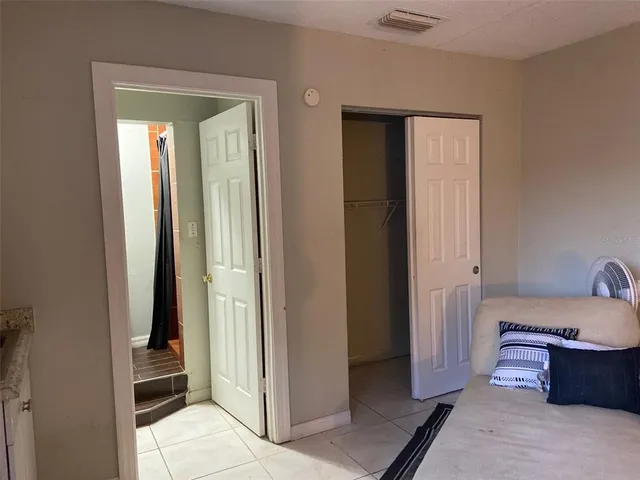 a bedroom with a bed and a dresser