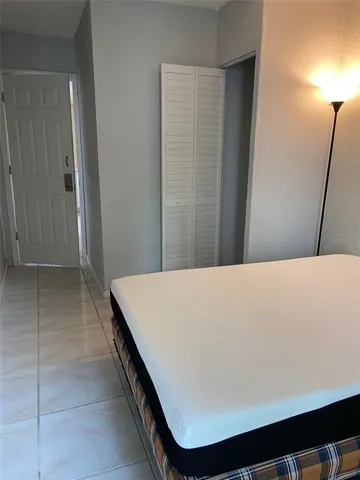 a bed sitting in a bedroom next to a window