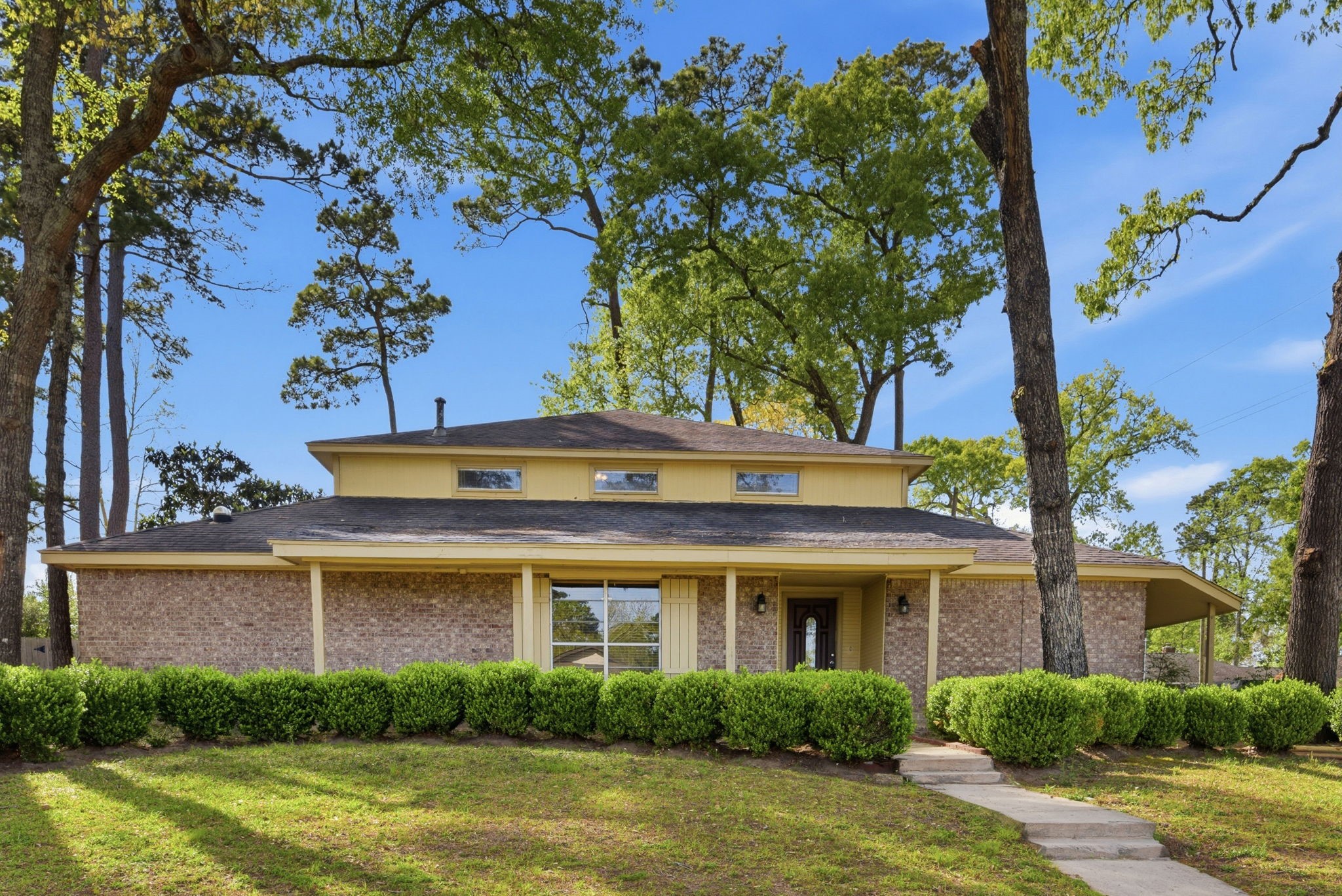 a front view of a house with garden