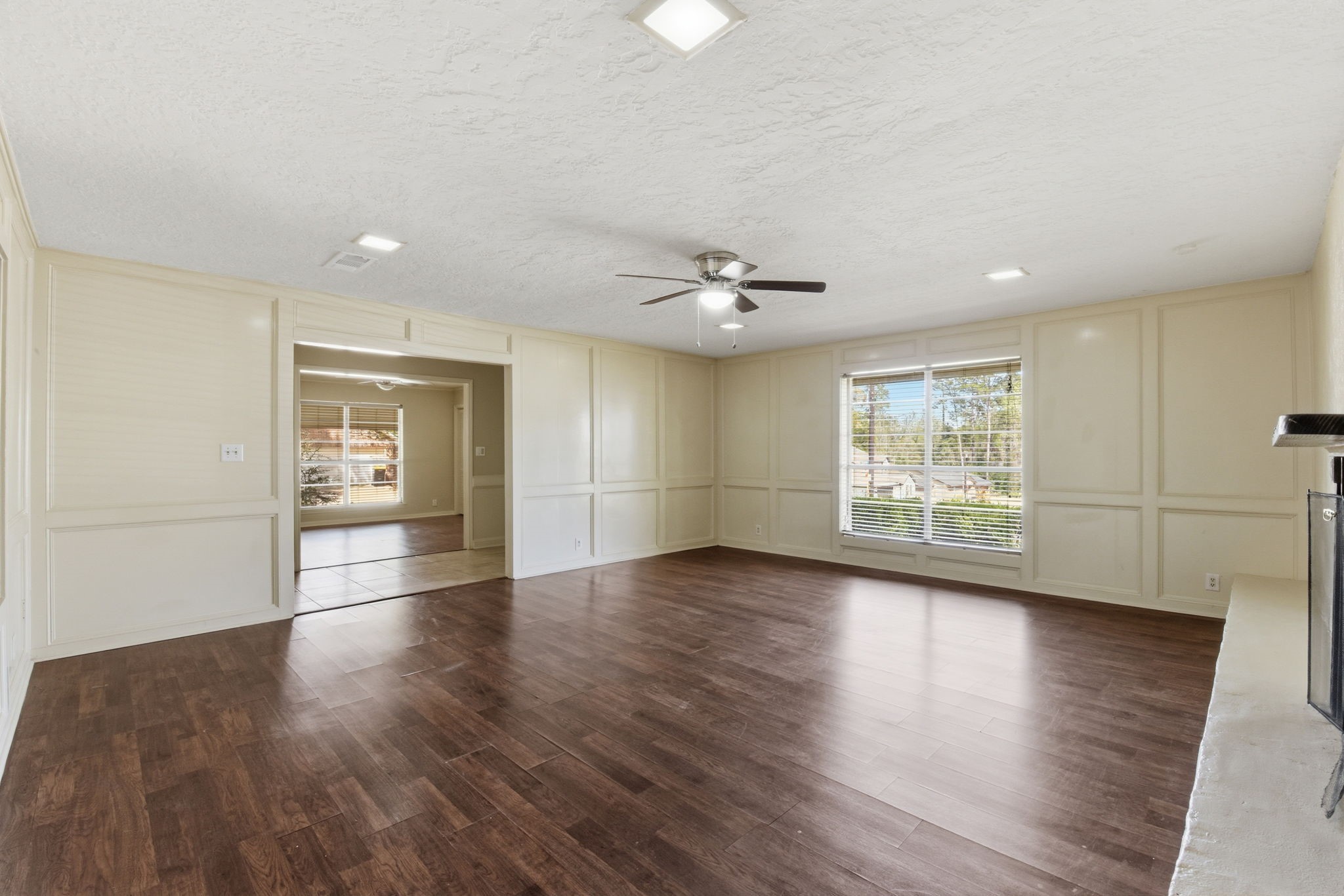 9052 Zapata Way Willis, TX 77378 - Photo 11 of 45 a view of an empty room with wooden floor and a window