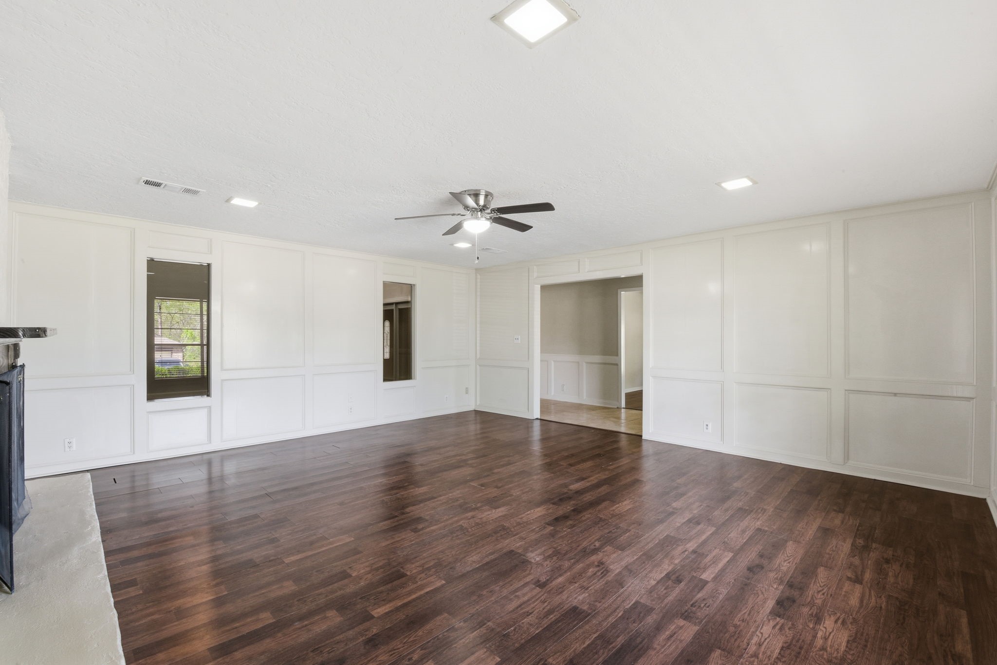 9052 Zapata Way Willis, TX 77378 - Photo 12 of 45 a view of an empty room with wooden floor and a window