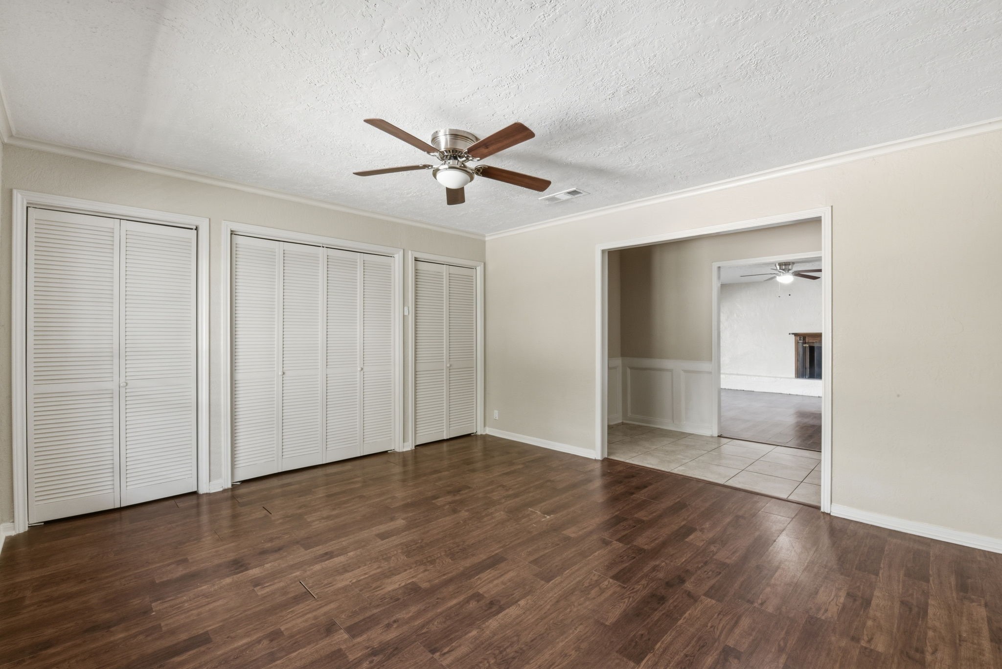 9052 Zapata Way Willis, TX 77378 - Photo 14 of 45 a view of empty room with wooden floor and fan