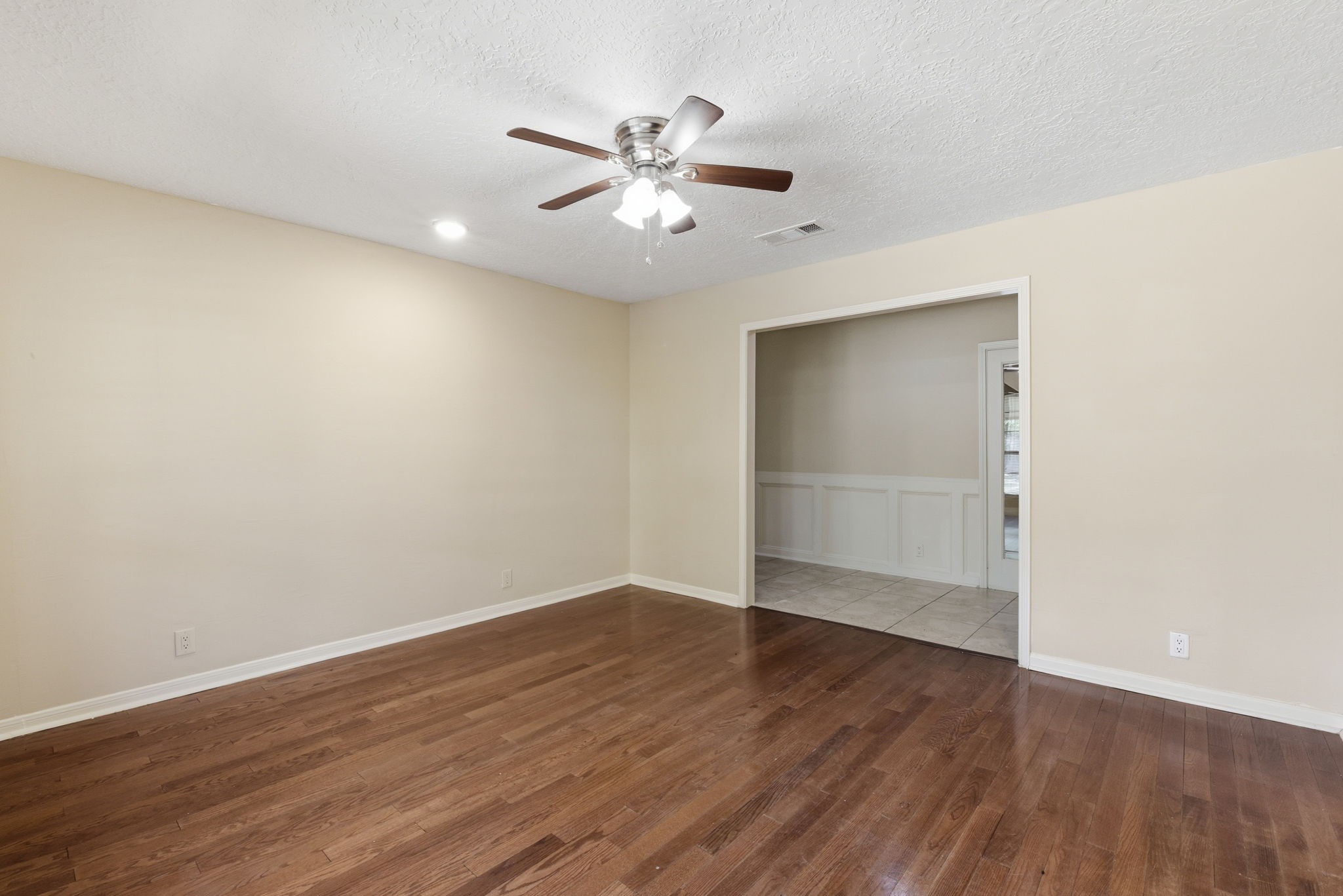 9052 Zapata Way Willis, TX 77378 - Photo 16 of 45 a view of an empty room with wooden floor