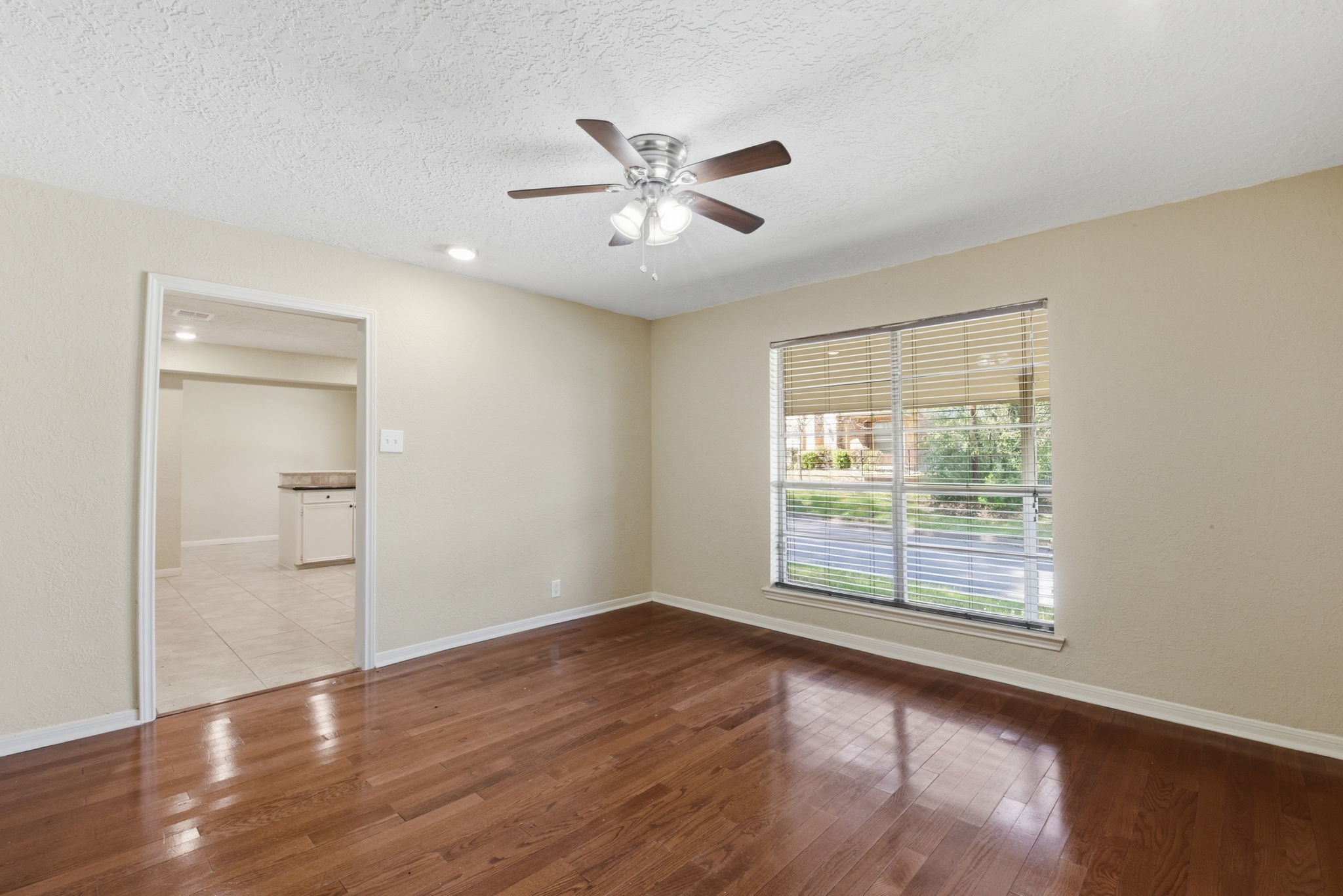 9052 Zapata Way Willis, TX 77378 - Photo 17 of 45 wooden floor in an empty room with a window