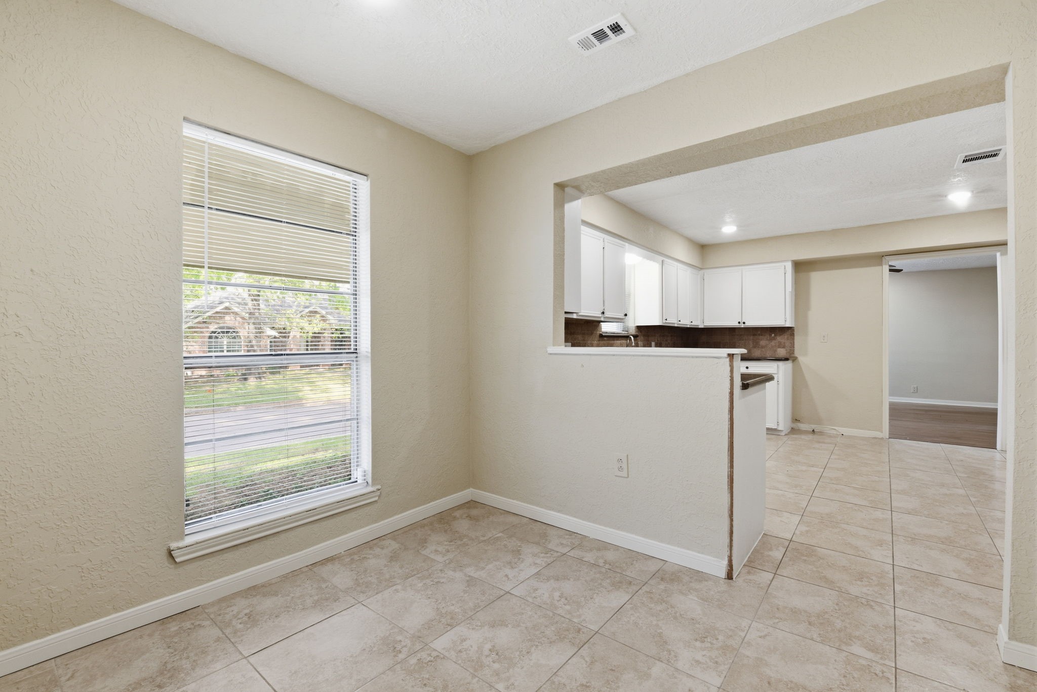 9052 Zapata Way Willis, TX 77378 - Photo 22 of 45 a view of a kitchen with a sink and a refrigerator