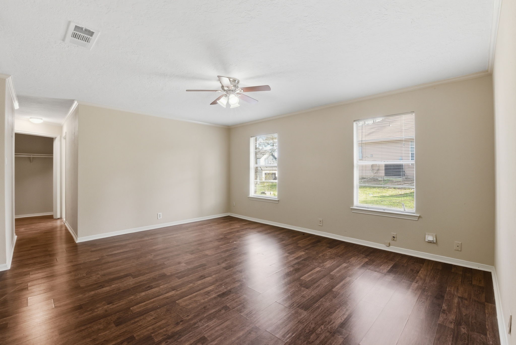9052 Zapata Way Willis, TX 77378 - Photo 25 of 45 a view of an empty room with wooden floor and a window