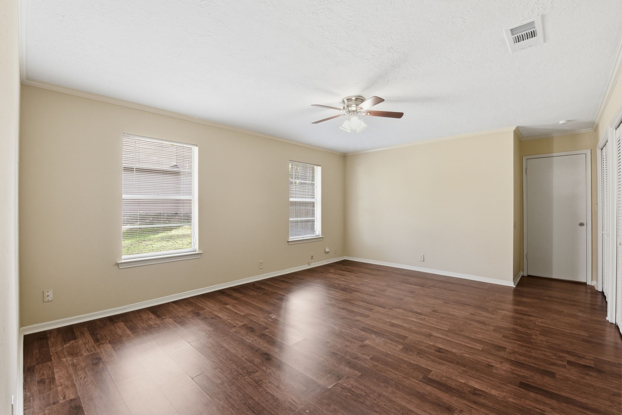 9052 Zapata Way Willis, TX 77378 - Photo 26 of 45 a view of an empty room with wooden floor and a window