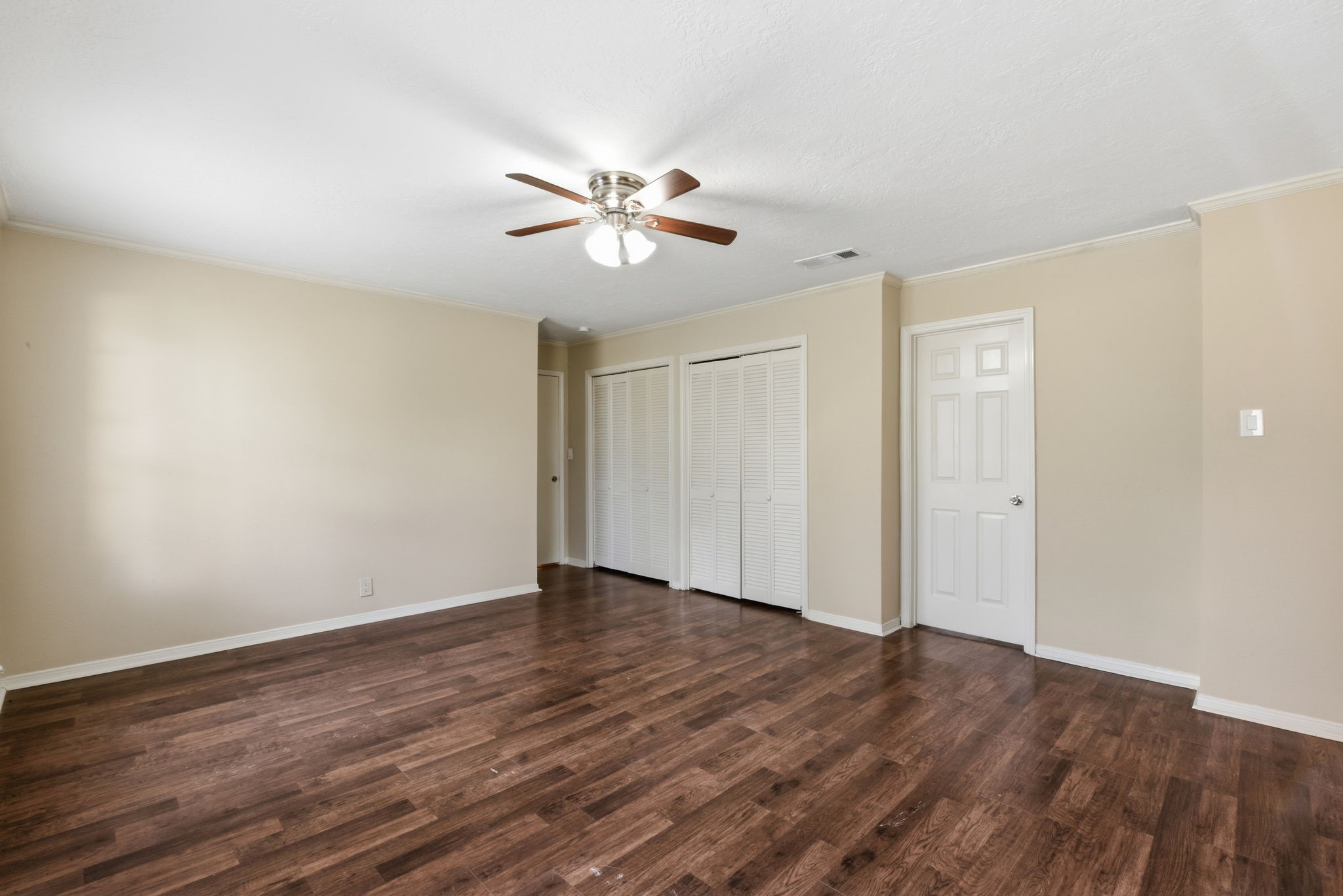 9052 Zapata Way Willis, TX 77378 - Photo 27 of 45 a view of an empty room with wooden floor and a ceiling fan