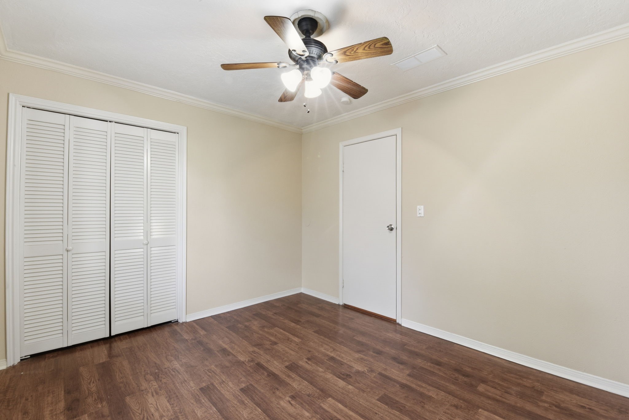 9052 Zapata Way Willis, TX 77378 - Photo 35 of 45 an empty room with wooden floor and ceiling fan