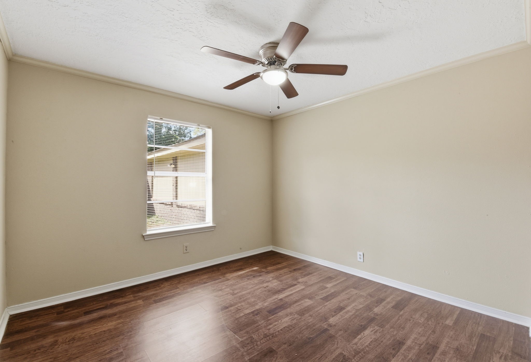 9052 Zapata Way Willis, TX 77378 - Photo 36 of 45 an empty room with wooden floor fan and windows