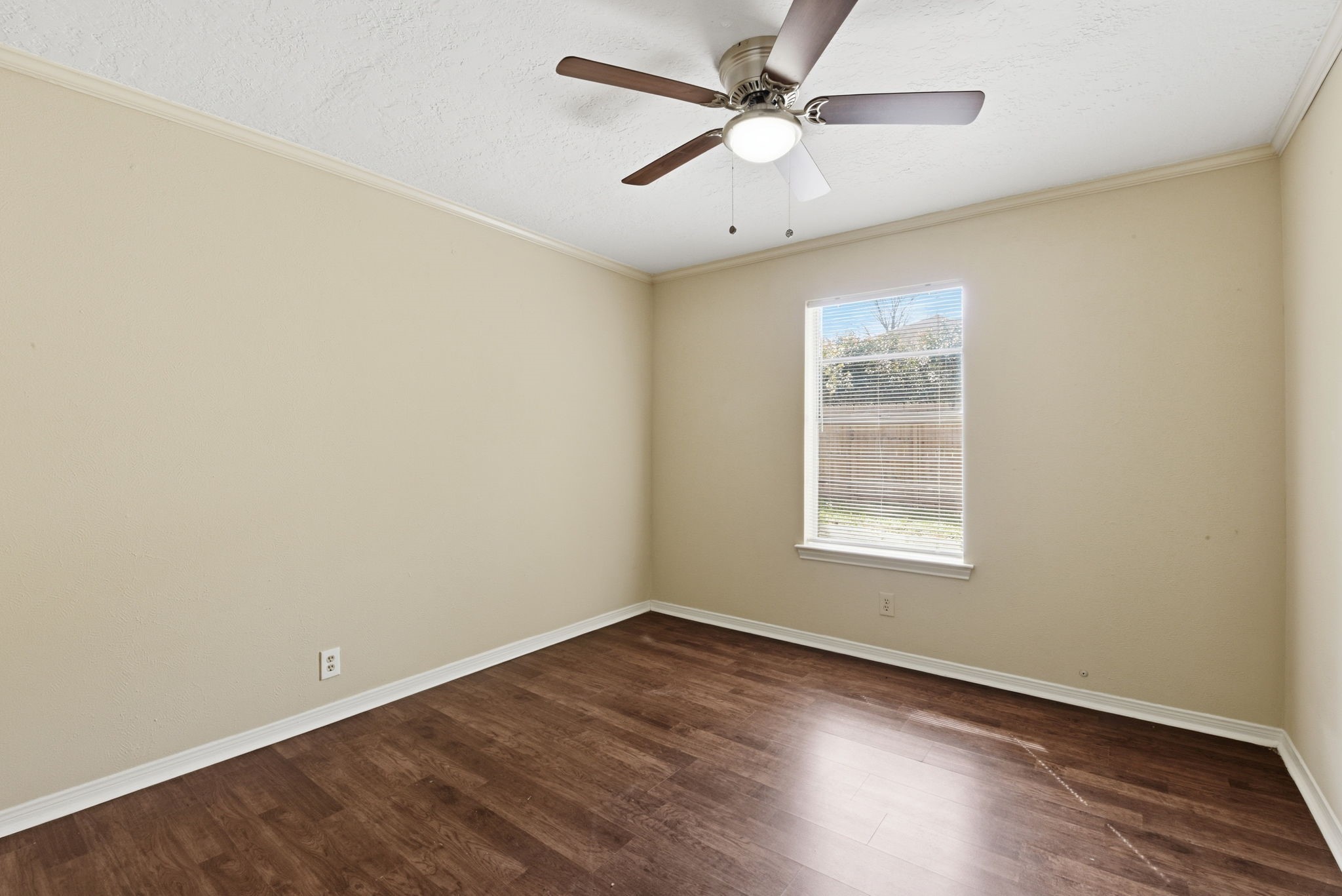 9052 Zapata Way Willis, TX 77378 - Photo 38 of 45 an empty room with wooden floor ceiling fan and windows