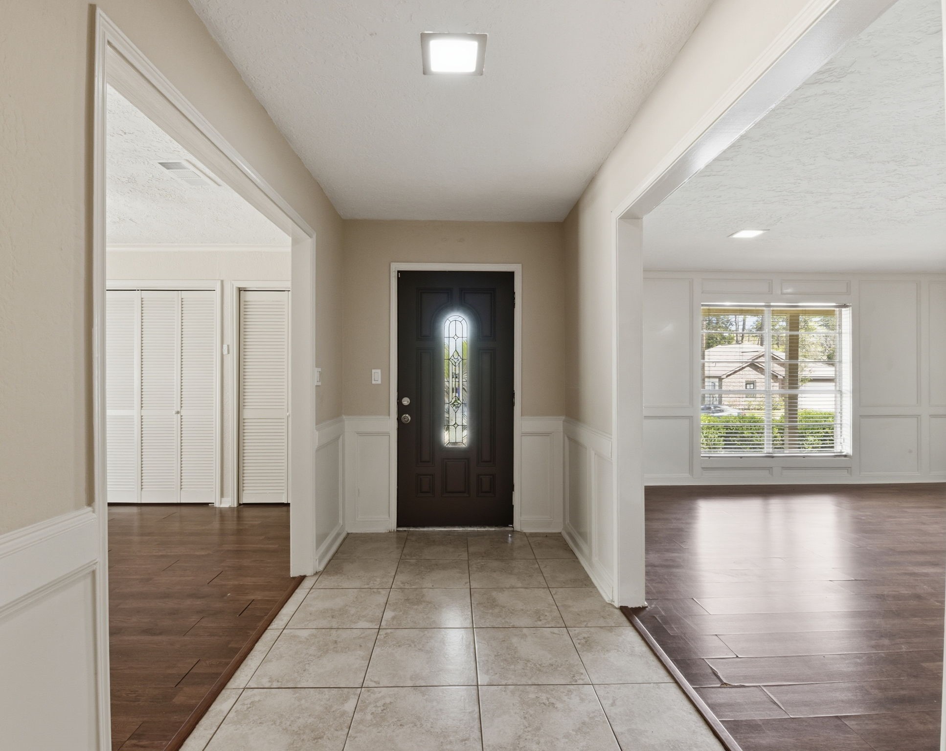 9052 Zapata Way Willis, TX 77378 - Photo 8 of 45 a view of a hallway with windows and chandelier