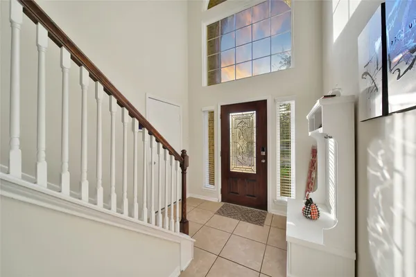 a view of staircase with railing and white walls