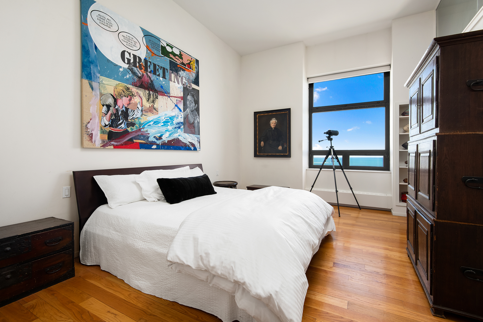 680 North Lake Shore Drive, Unit 1602 Chicago, IL 60611 - Photo 12 of 30 a bedroom with a bed and a painting on the wall