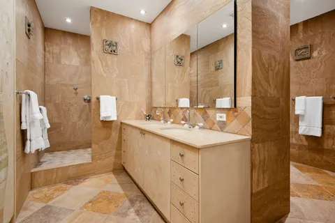 a bathroom with a sink toilet and shower