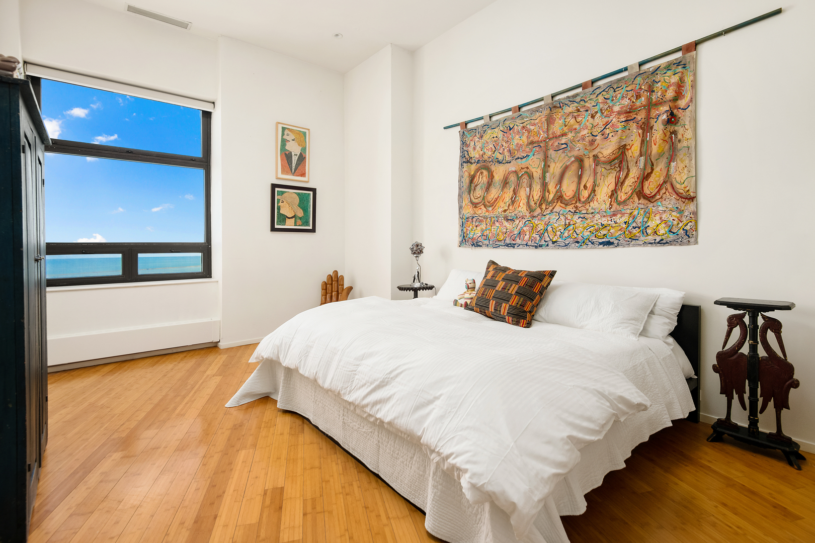 680 North Lake Shore Drive, Unit 1602 Chicago, IL 60611 - Photo 16 of 30 a bedroom with a bed and a painting on the wall