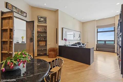a living room with furniture and a book shelf