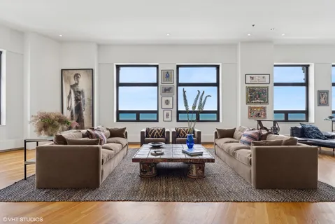 a living room with furniture potted plant and a window