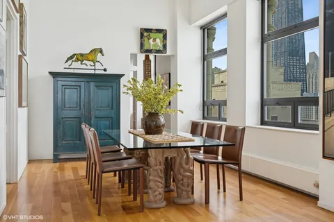 a kitchen with stainless steel appliances a table chairs and a refrigerator